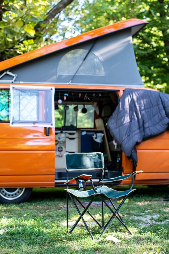Orange campervan with pop-top and side door open